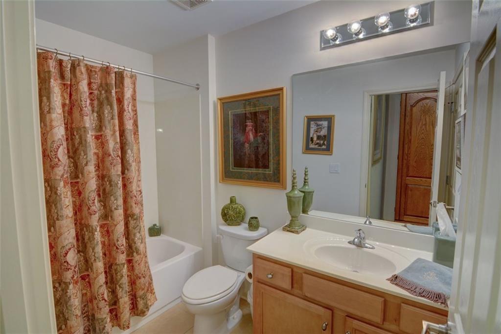910 Brook Knoll Lane Cumming, GA 30041 - Photo 35 of 36 a bathroom with a granite countertop sink toilet and shower