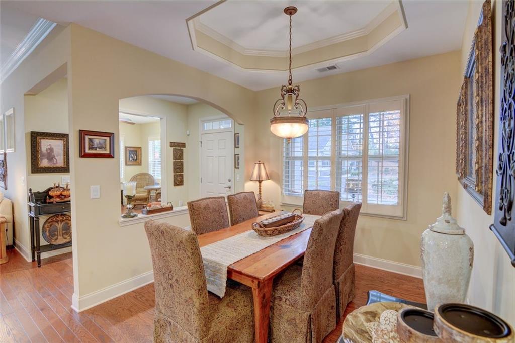 910 Brook Knoll Lane Cumming, GA 30041 - Photo 8 of 36 a view of a dining room with furniture window and wooden floor