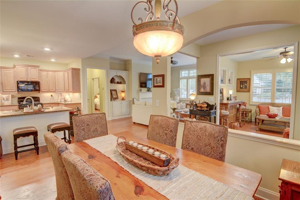 910 Brook Knoll Lane Cumming, GA 30041 - Photo 9 of 36 a living room with furniture a dining table and kitchen view