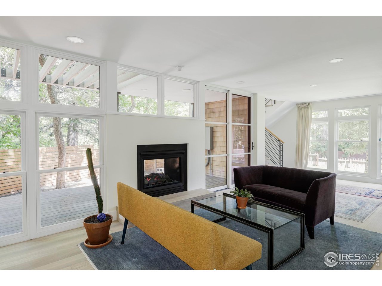 580 Pleasant Street Boulder, CO 80302 - Photo 8 of 29 a living room with furniture a fireplace and a large window