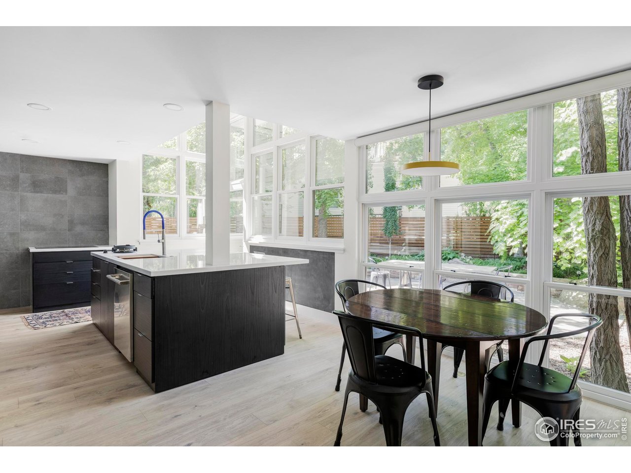 580 Pleasant Street Boulder, CO 80302 - Photo 10 of 29 a kitchen with a dining table chairs and large window