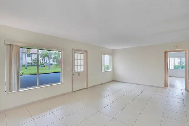 a view of an empty room with glass door