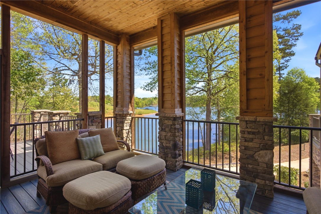 578 Sunset Point Drive West Union, SC 29696 - Photo 2 of 46 This inviting screened porch offers captivating views of the serene lake and lush surroundings.