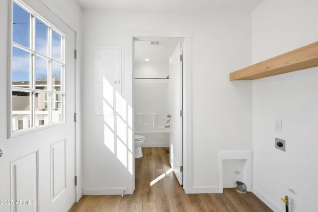 a view of a hallway with wooden floor and entryway