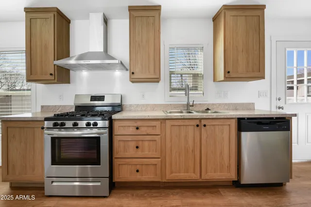a kitchen with granite countertop a sink a stove and cabinets