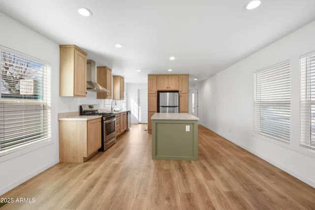 a kitchen with stainless steel appliances kitchen island granite countertop a stove and a sink