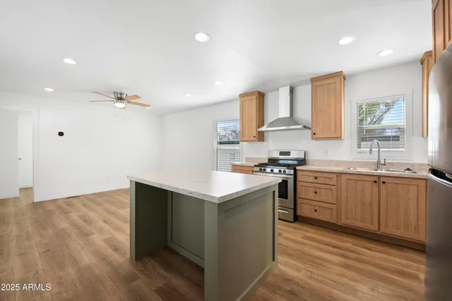 a kitchen with stainless steel appliances granite countertop a sink stove and refrigerator