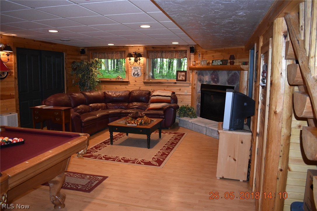 9736 Liberty Road Twinsburg, OH 44087 - Photo 21 of 31 huge entertainment room ( 29x17') with full sized windows, laminated floor, wood burning fireplace with gas logs, wired for sound