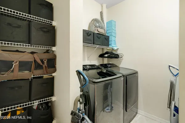 a kitchen with kitchen island a refrigerator stove microwave and cabinets