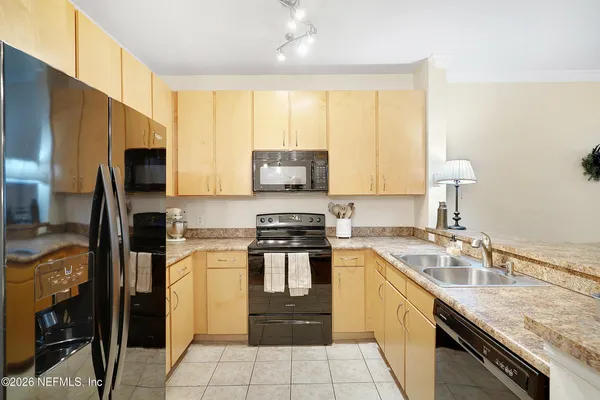 a kitchen with a sink stove and refrigerator