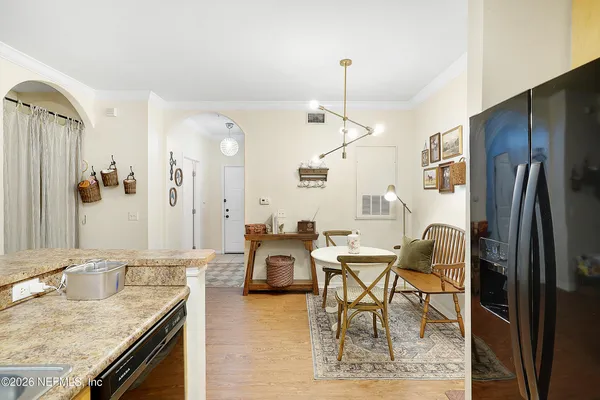 a view of a kitchen area kitchen island furniture wooden floor and a chandelier