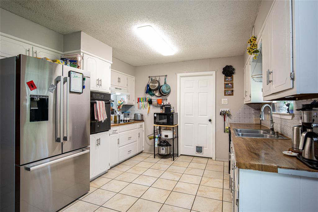 817 South Old Temple Road Lorena, TX 76655 - Photo 5 of 17 a kitchen with stainless steel appliances granite countertop a refrigerator and a sink