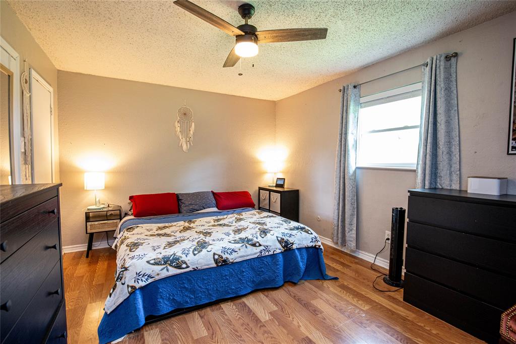 817 South Old Temple Road Lorena, TX 76655 - Photo 6 of 17 a bedroom with a bed and wooden floor