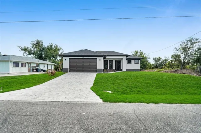 a front view of a house with a yard and garage