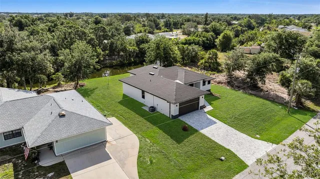 an aerial view of a house with a big yard