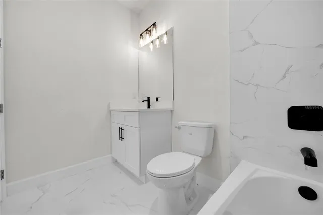 a bathroom with a sink a toilet and a shower