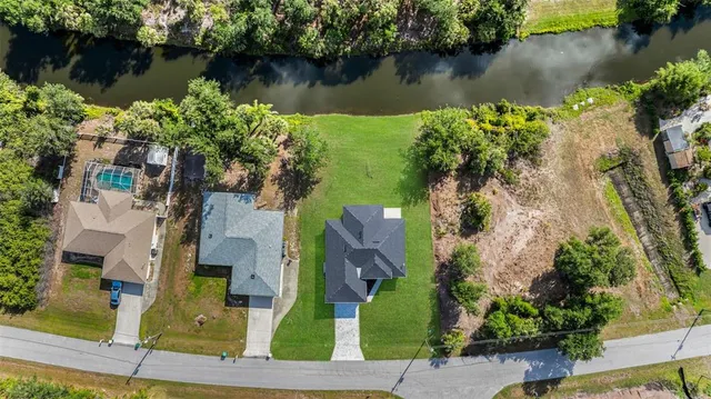 an aerial view of a house with a yard and a garden