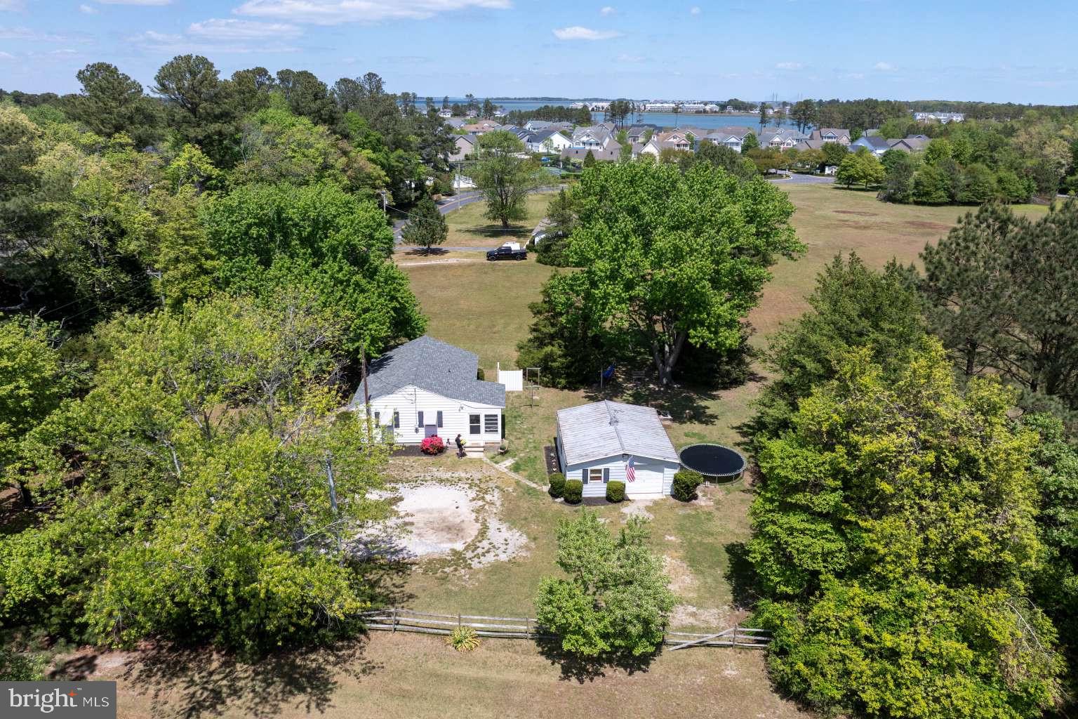 37186 Clubhouse Road Ocean View, DE 19970 - Photo 12 of 14 an aerial view of a house with a garden and lake view