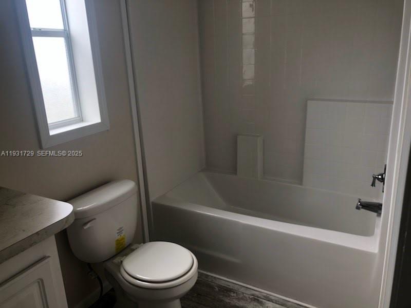22884 Dolphin Road, Unit B Boca Raton, FL 33428 - Photo 11 of 14 a white toilet sitting next to a bath tub