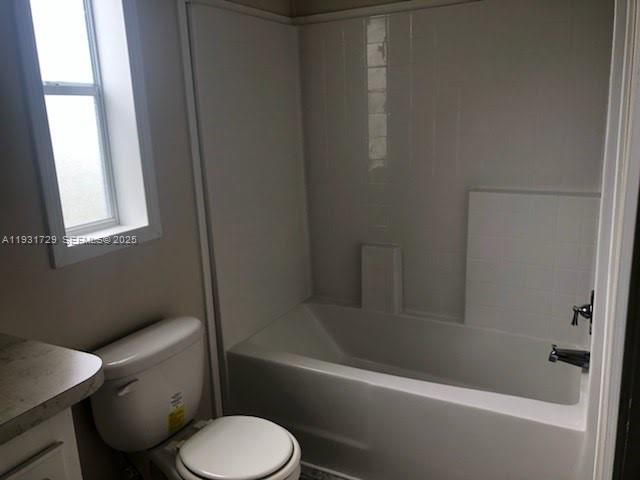22884 Dolphin Road, Unit B Boca Raton, FL 33428 - Photo 13 of 14 a white toilet and tub next to a window