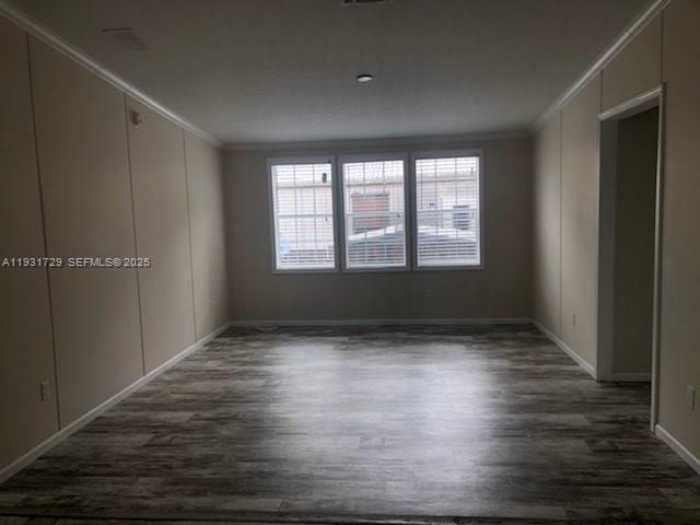 22884 Dolphin Road, Unit B Boca Raton, FL 33428 - Photo 2 of 14 a view of an empty room with wooden floor and a window