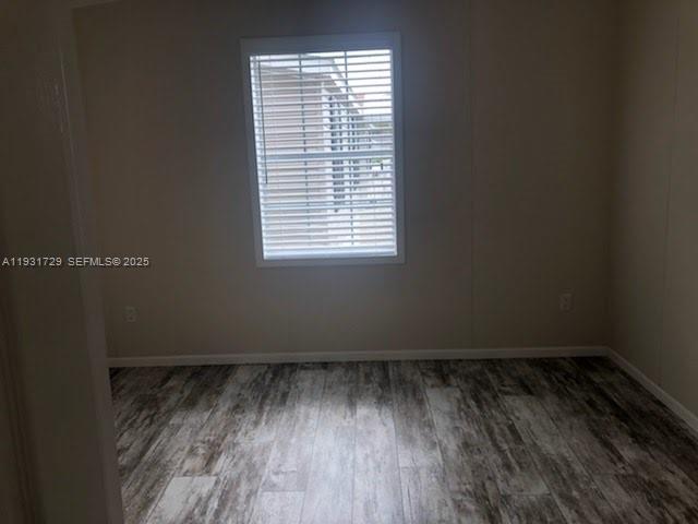 22884 Dolphin Road, Unit B Boca Raton, FL 33428 - Photo 7 of 14 a view of a room with wooden floor and a window