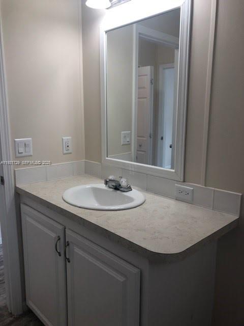 22884 Dolphin Road, Unit B Boca Raton, FL 33428 - Photo 8 of 14 a bathroom with a sink and a mirror