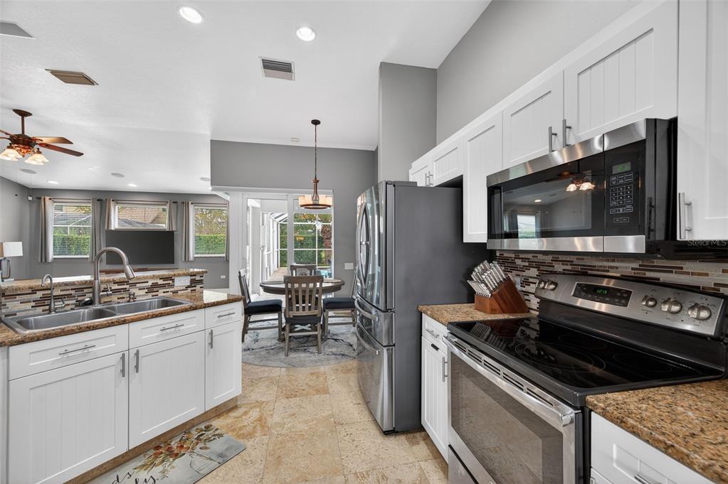 10539 Gooseberry Court Trinity, FL 34655 - Photo 12 of 52 a kitchen with a stove and a microwave