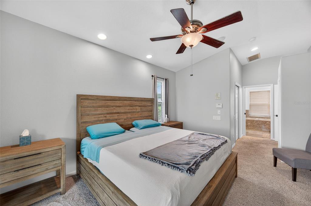 10539 Gooseberry Court Trinity, FL 34655 - Photo 17 of 52 a bed room with a bed and a chandelier