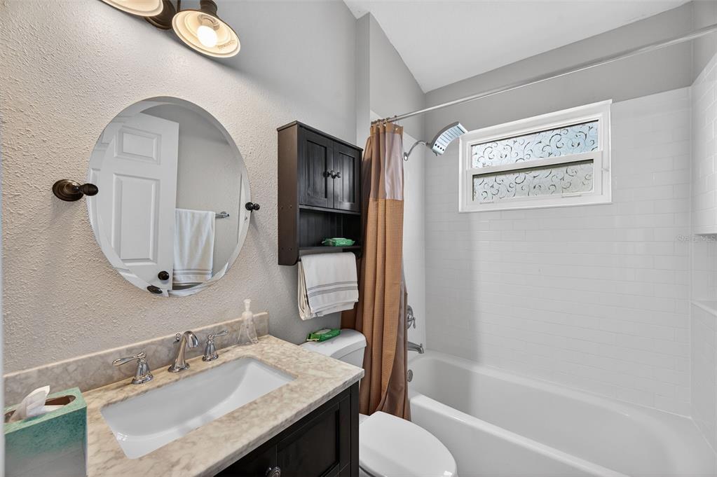 10539 Gooseberry Court Trinity, FL 34655 - Photo 24 of 52 a bathroom with a granite countertop sink toilet and shower