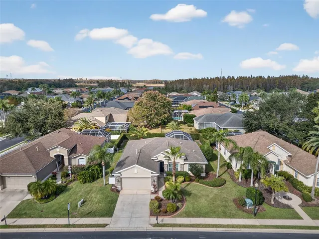 an aerial view of a house with garden space and ocean view