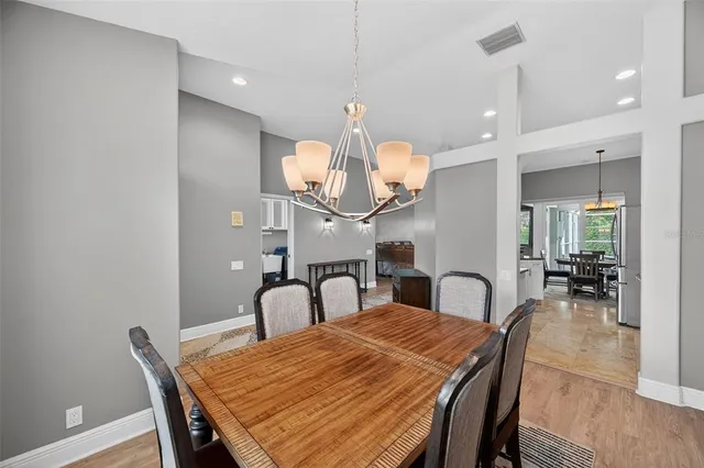 a dining room with furniture and wooden floor