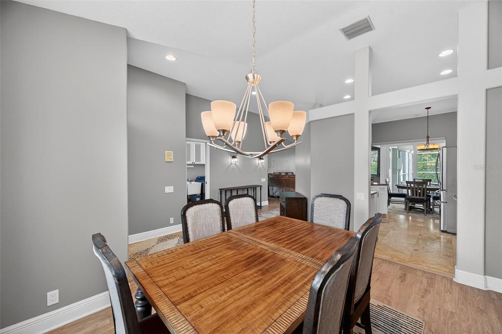 10539 Gooseberry Court Trinity, FL 34655 - Photo 5 of 52 a dining room with furniture and wooden floor