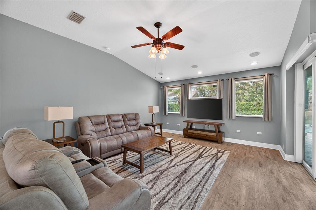 10539 Gooseberry Court Trinity, FL 34655 - Photo 7 of 52 a living room with furniture and a flat screen tv
