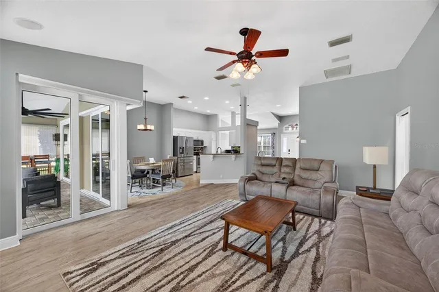 a living room with furniture and kitchen view
