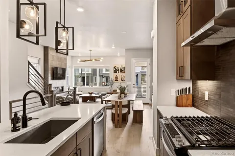 a kitchen with stainless steel appliances a sink stove and cabinets