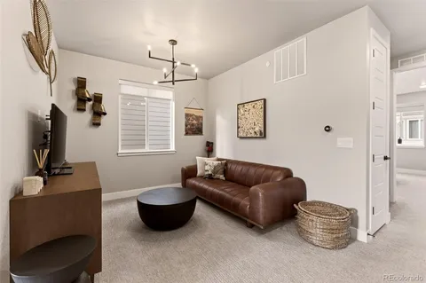 a living room with furniture rug and window