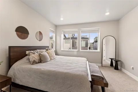 a bedroom with a bed and a large window