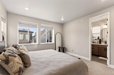 a bedroom with a bed and a large mirror