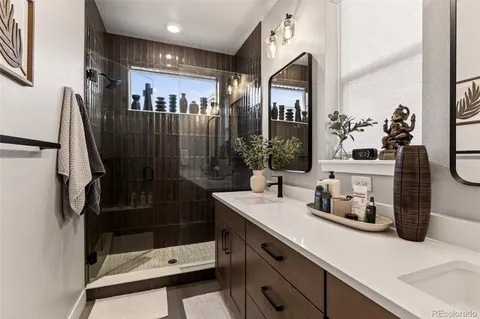 a bathroom with a shower sink and mirror