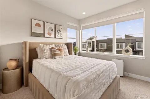 a bedroom with a large bed and a large window
