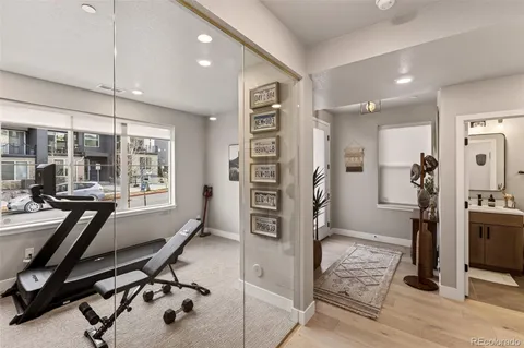 a view of a hallway with white walls and stairs