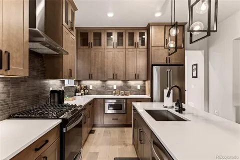 a kitchen with stainless steel appliances a sink stove and cabinets