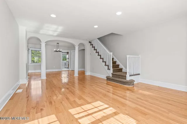 a view of an entryway with wooden floor