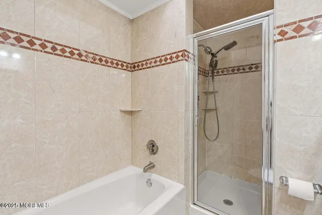 a bathroom with a shower and a bathtub