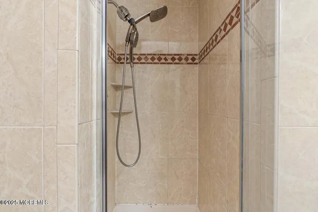 a bathroom with a glass shower door