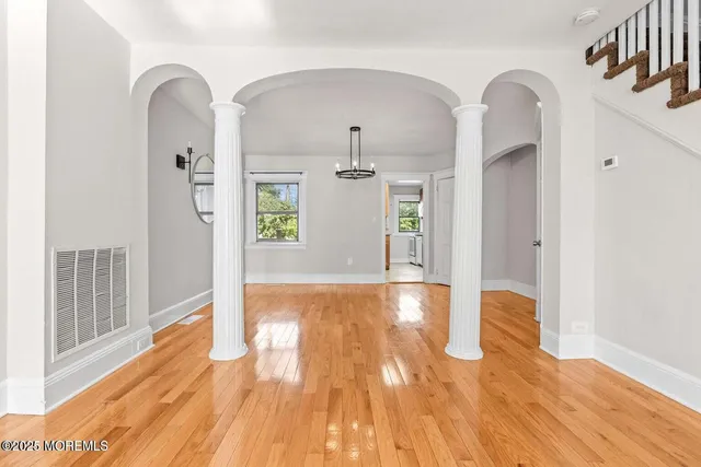 a view of a room with wooden floor and cabinet