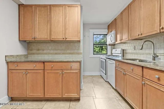 a kitchen with stainless steel appliances granite countertop a refrigerator sink and cabinets
