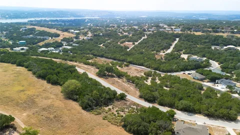 an aerial view of city lake and residential houses with outdoor space and trees
