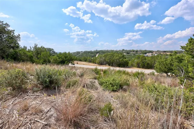 a view of a lake with houses in back
